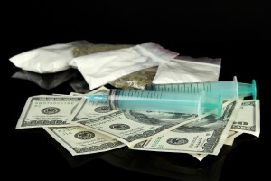 Drugs, money and  syringes, isolated on black